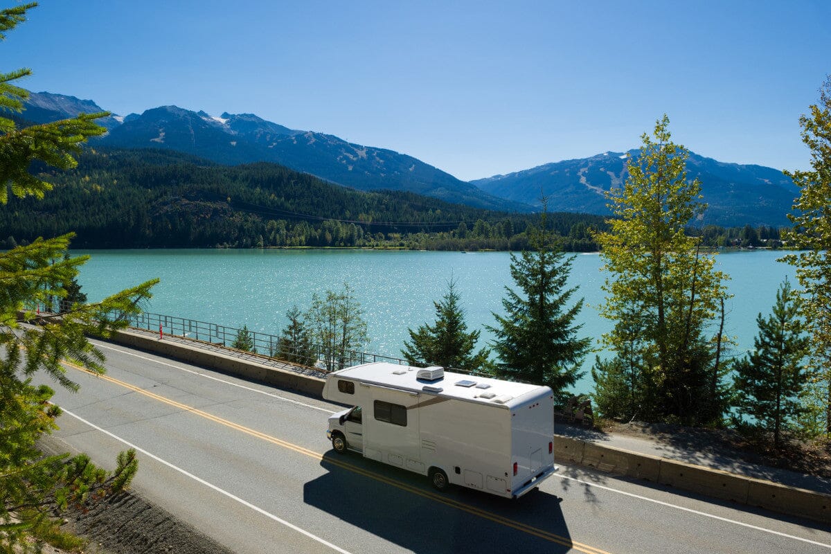 RV driving along a scenic moutanin view on a highway.
