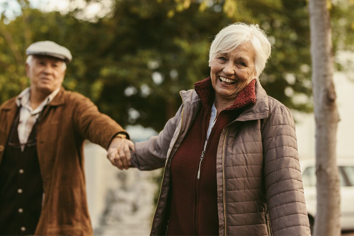 happy senior couple walking outdoors on a winter day
