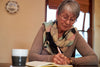 older lady sitting at a table journaling