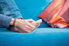 a married woman holding her foot on a blue couch