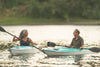 two seniors kayaking on a lake