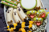 various healthy Halloween treats on a white platter