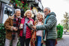 group of 4 seniors traveling during Christmas time, reviewing a map on where to go.