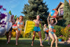 Group of excited seniors in swimsuits, getting ready to jump into a pool.