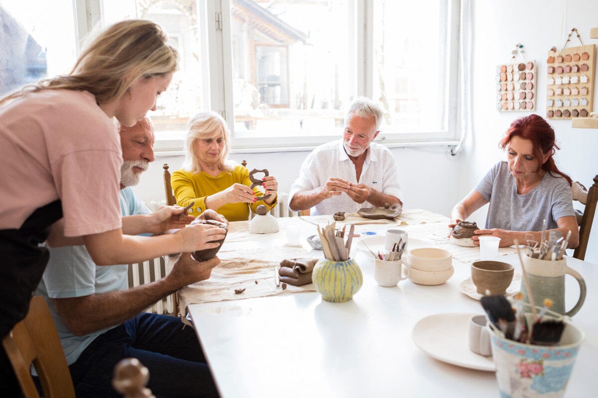 group of seniors making pottery