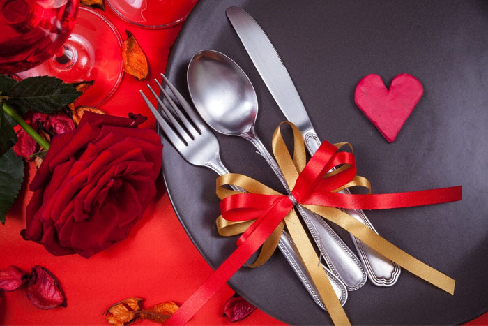 plate and silverware surround by hearts and roses