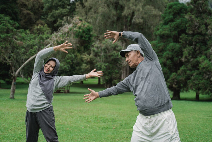 senior couple doing simple stretches outside together