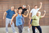 group of seniors dancing at a gym