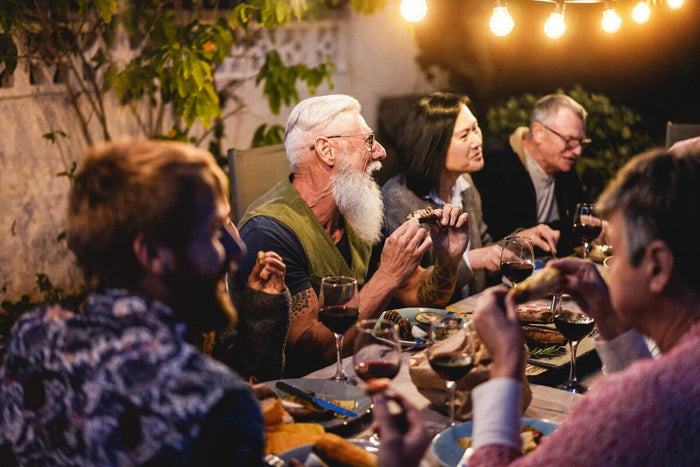 group of people gathered together to enjoy a cookout at night